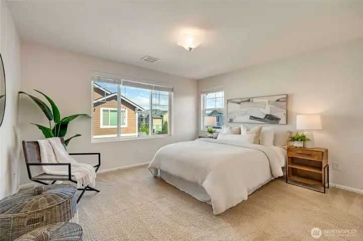 The primary bedroom features abundant space, a walk-in closet, and a spa-like ensuite with dual sinks, modern finishes, and a walk-in shower.