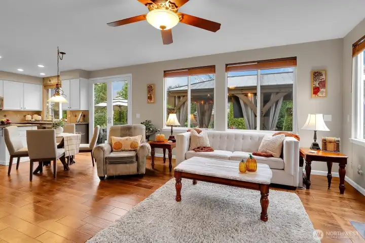 Open concept kitchen flows to family room with hardwood floors and gas fireplace