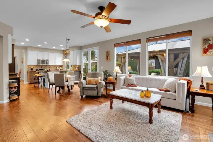 Open concept kitchen flows to family room with hardwood floors and gas fireplace