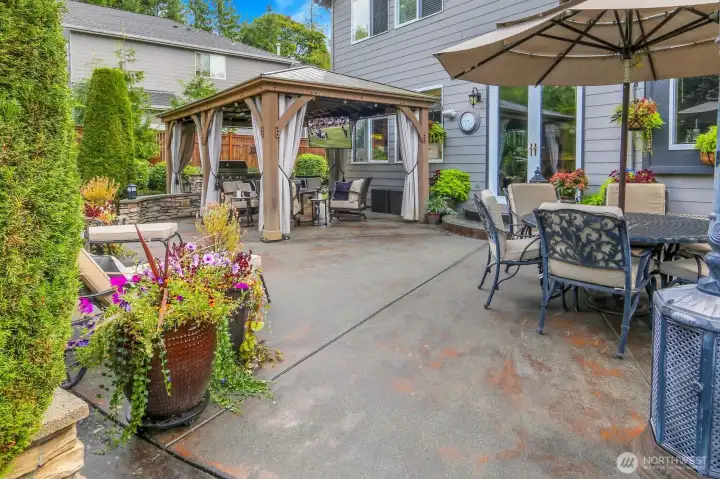 Outside living at it's best! Gazebo, stone island with grill and fridge, heaters, and TV included!