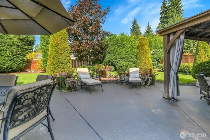 Outside living at it's best! Gazebo, stone island with grill and fridge, heaters, and TV included!