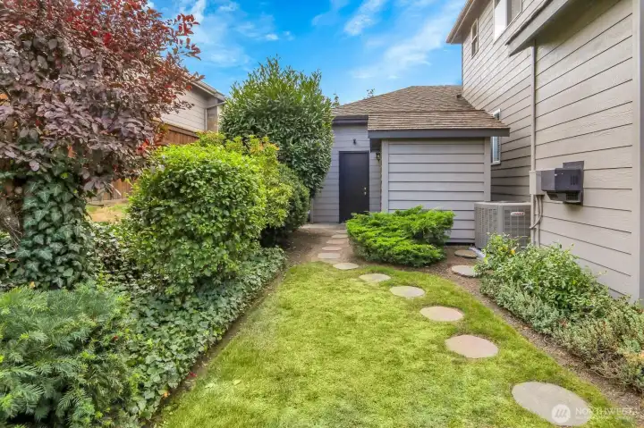 Extra space on the side of the home. Look at that A/C unit!
