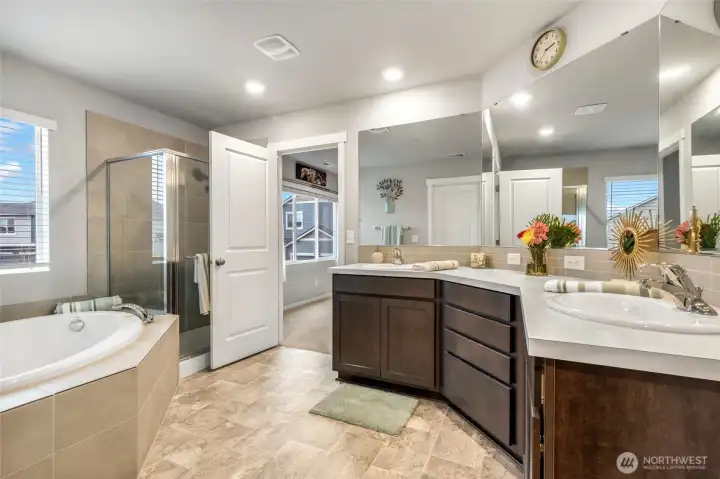Very spacious primary bathroom wth lots of counter space and large soaking tub and a roomy shower.