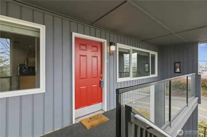 Welcome home! This inviting entry with its charming red door and cozy covered walkway sets the tone for a warm and comfortable living space inside.