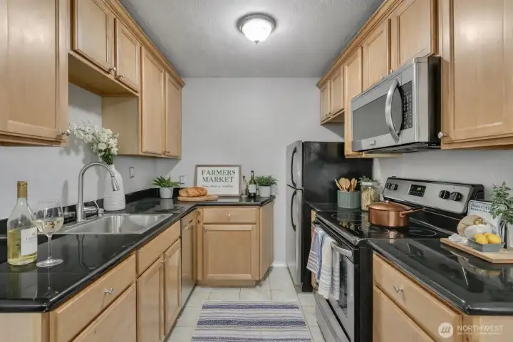 The kitchen features generous cabinet space, modern countertops, and an efficient layout, ideal for both daily use and hosting guests