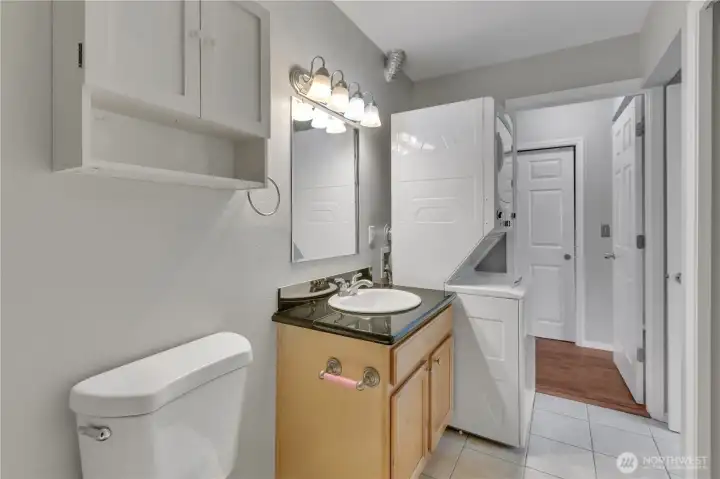 Another view of the master bathroom showcases a clean, bright space with a full tub and shower, complemented by a spacious vanity and modern lighting for everyday comfort.