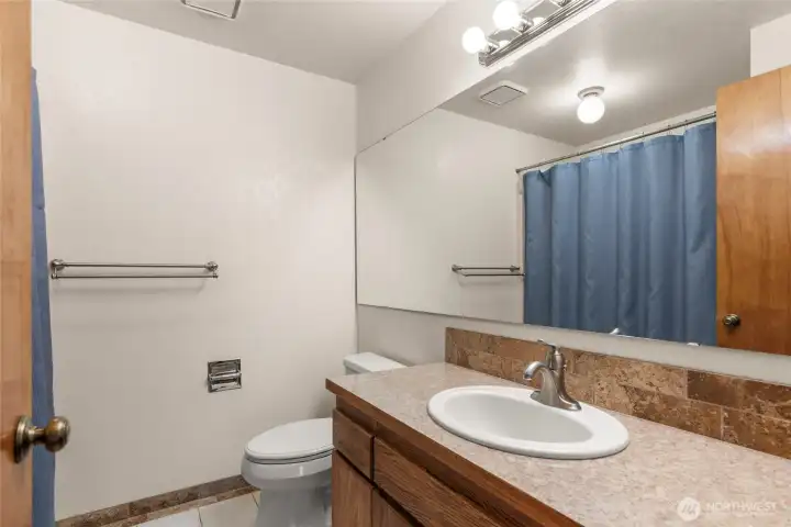 Full bath between second bedroom & laundry room.