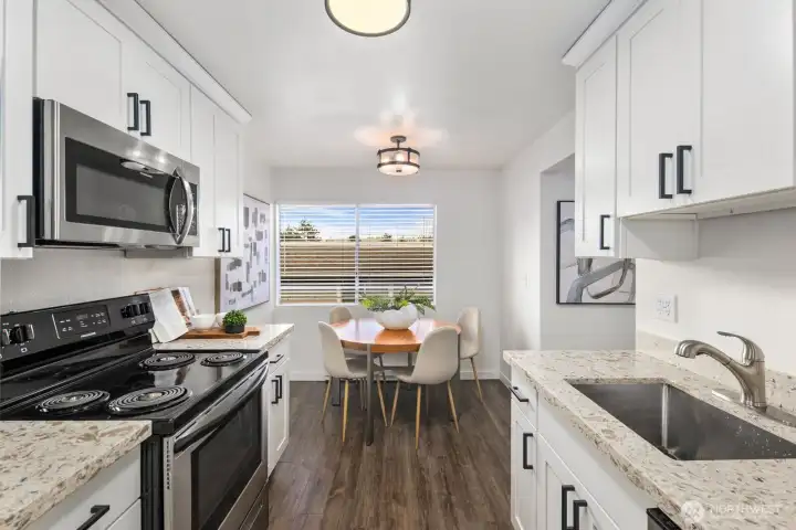 Updated chef's kitchen leads to formal dining area.