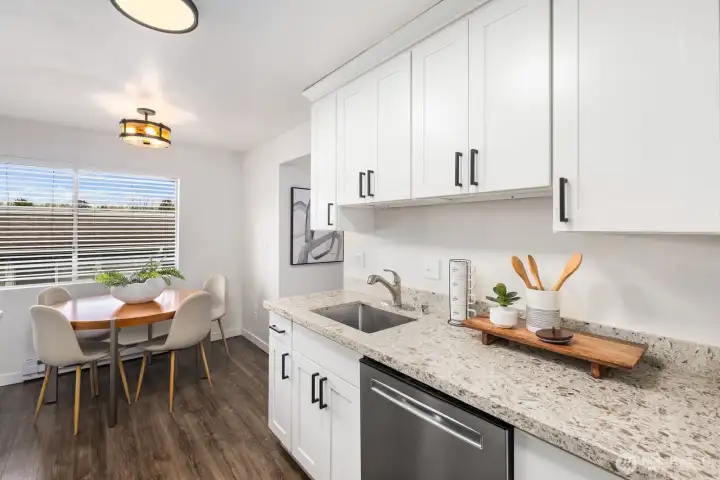 Updated chef's kitchen leads to formal dining area.