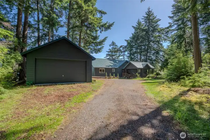A pleasant driveway through tall evergreen leads to the 105 Windfall. A two car garage welcomes you.
