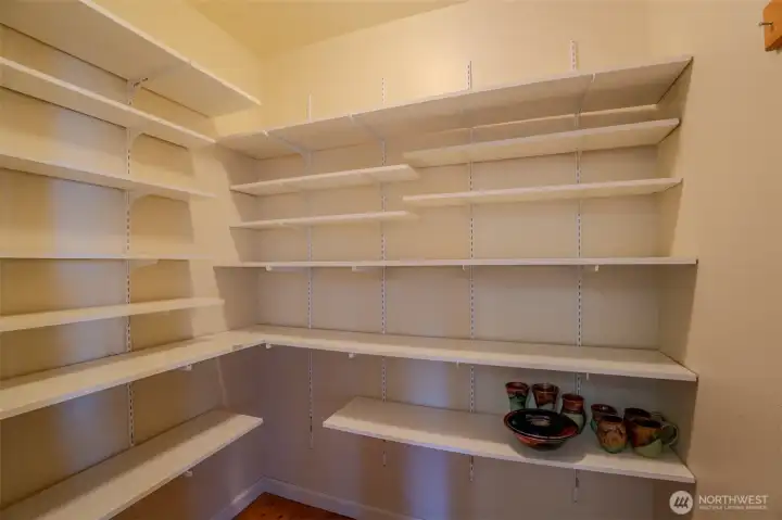 Spacious walk-in pantry with easy access to the kitchen and laundry.room.