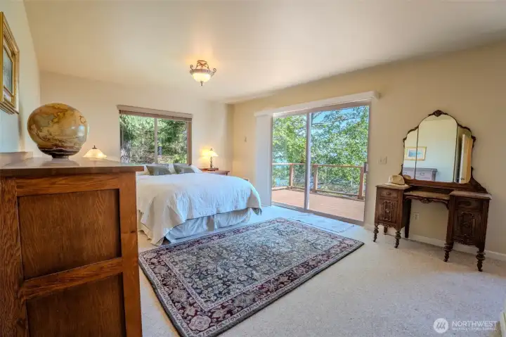 The primary suite opens directly to the deck through a patio door.