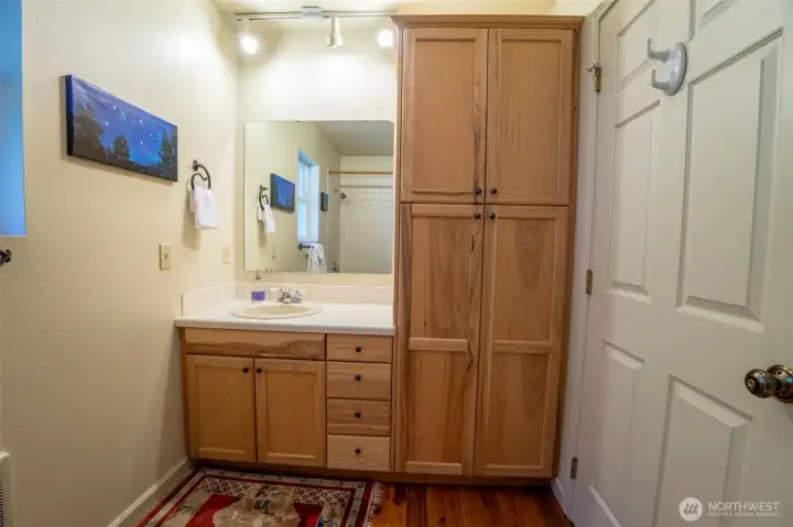Generous bathroom storage with dedicated linen space.