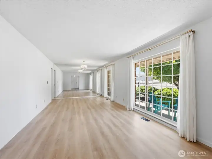 ight-filled living room with floor-to-ceiling original windows and stunning Saddle Rock views. ight-filled living room with floor-to-ceiling original windows and stunning Saddle Rock views.