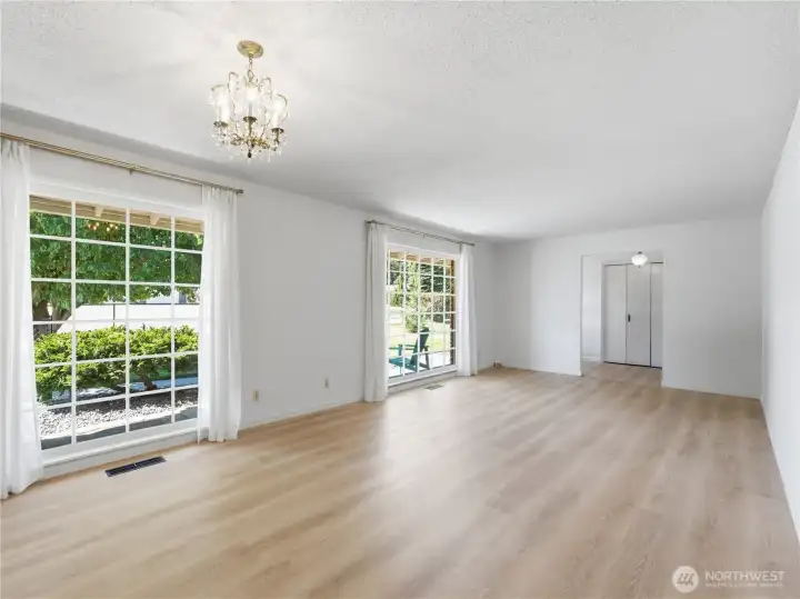 Expansive front living space flooded with natural light through timeless mid-century windows. Expansive front living space flooded with natural light through timeless mid-century windows.