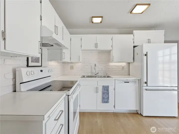 Updated kitchen with modern appliances, abundant cabinetry, and functional workspace. Updated kitchen with modern appliances, abundant cabinetry, and functional workspace.