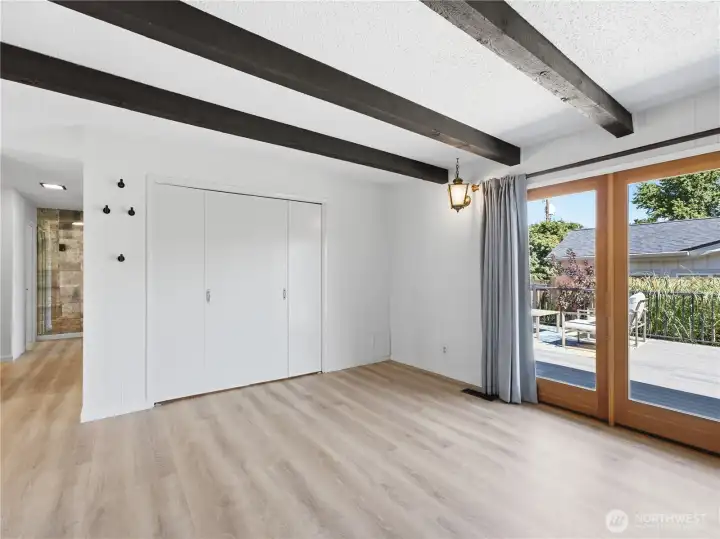 Warm and welcoming gathering space featuring a painted brick fireplace, exposed beams, and abundant natural light. Warm and welcoming gathering space featuring a painted brick fireplace, exposed beams, and abundant natural light.