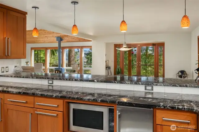 A view from the kitchen overlooking the dining & living rooms. The open floorplan allows for ongoing conversations while cooking. A beverage fridge is not pictured to the left.