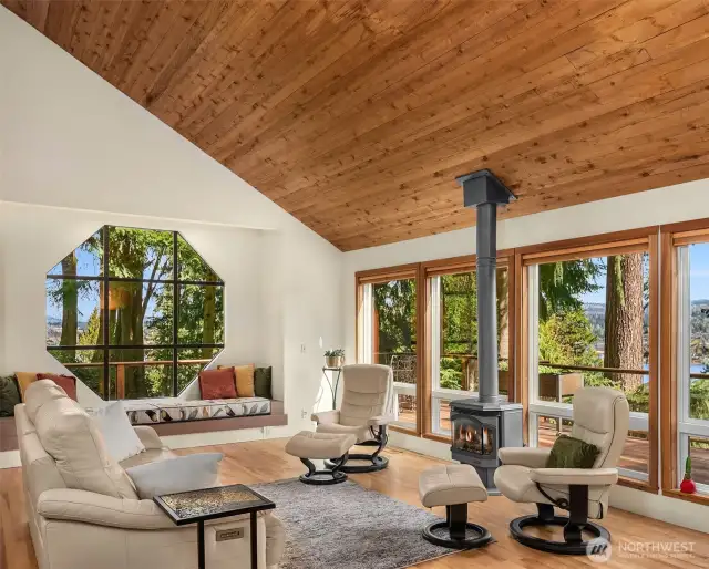 Looking southeast, the living room is a place to swoon over the vaulted ceiling and views to the lake. A cozy space!
