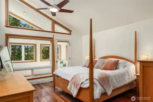 The primary suite offers a vaulted ceiling, ceiling fan and attached sunroom! To the right is the walk-in closet and two baths!