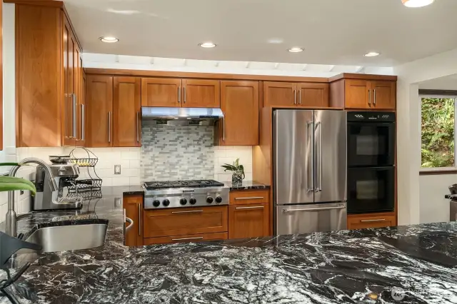 The stainless steel fridge was just installed. The granite counters are gorgeous & sleek.
