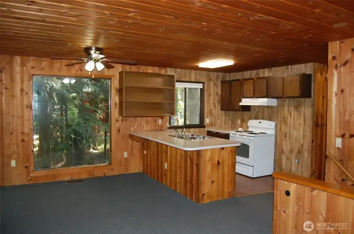 Kitchen eating bar seats 5 and open to dining area.