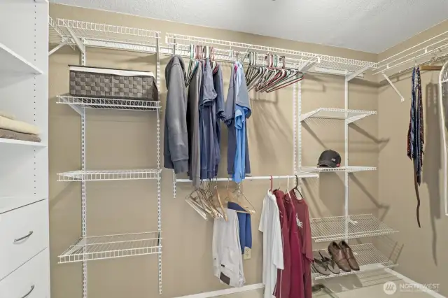 Primary bedroom walk-in closet with custom organizers.