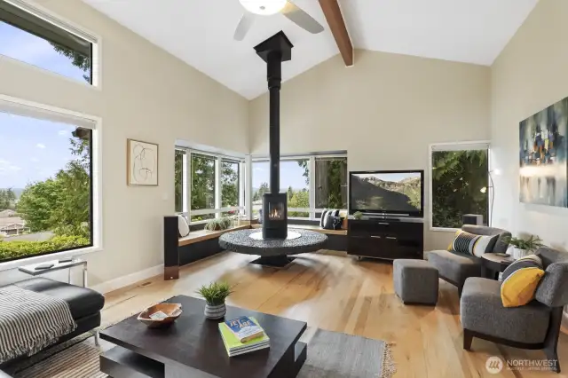 Adorable living room with lots of windows looking out at the Olympic Mountains and even peek-a-boo sound views.
