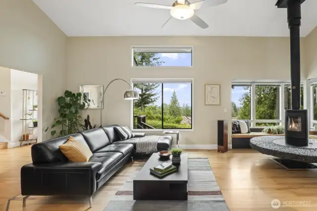 Gleaming hardwoods and Scandinavian wood stove perfect for gatherings or cozy evenings at home.