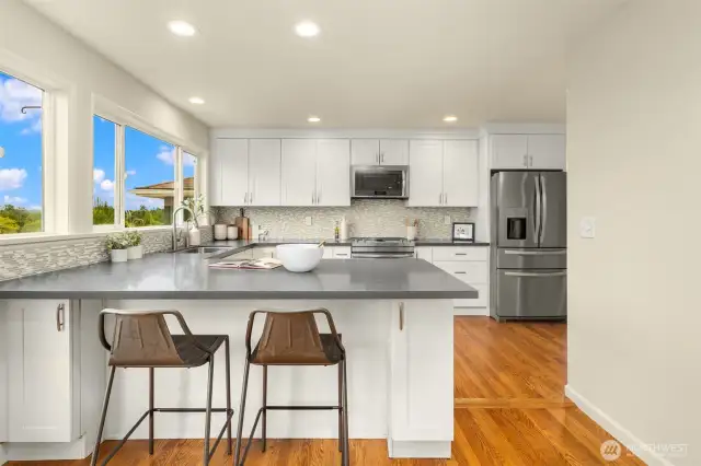 Updated kitchen with slab quartz counters.