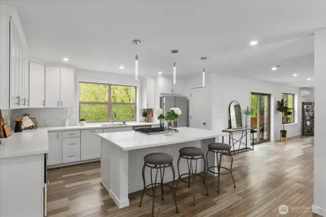 The oversized island offers seating for guests in this Chefs dream kitchen.