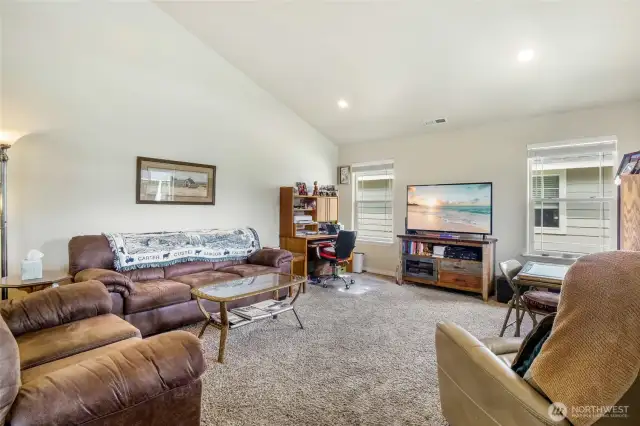 As you enter from the covered porch, you'll enter into the carpeted living room with vaulted ceilings. This is one of the more desirable floor plans in the community.