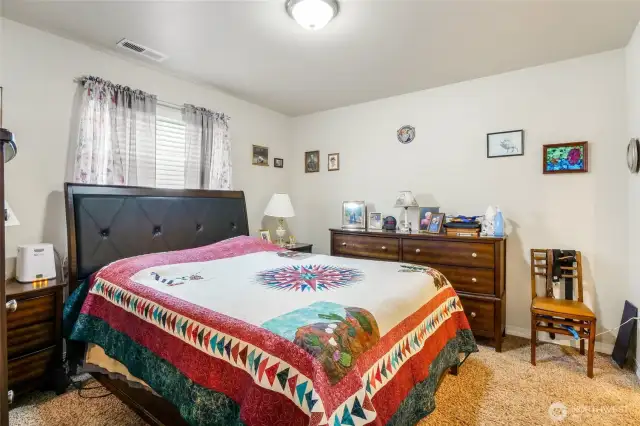This primary bedroom has a large walk-in closet and dual-sink bathroom.