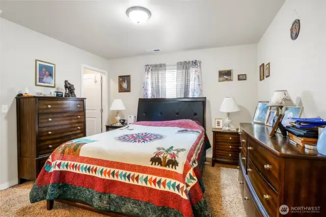 The bedroom doorway is to the left, and the bathroom is behind you.