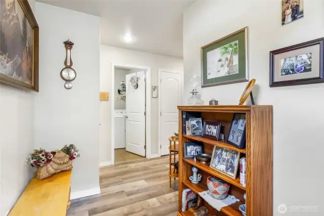The entryway foyer from the front door near the garage is quite spacious! The laundry/utility room is that open door across the way.