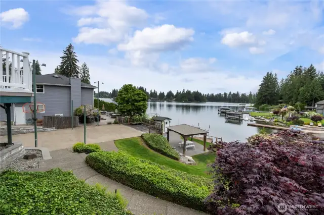 Property features level waterfront with patio and gazebo, sport court, dock, boat lift, bulkhead, and outbuildings.  Perfect for embracing lake life.