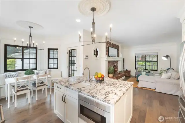 Beautifully remodeled kitchen with center island, eating area and access to covered back deck