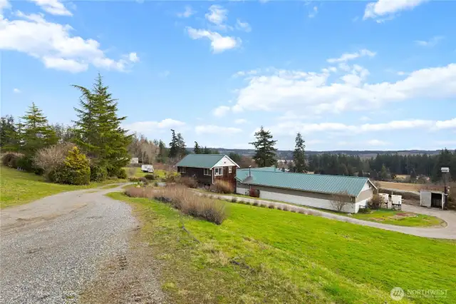 Expansive country property with a charming farmhouse, outbuildings, and sweeping territorial views.