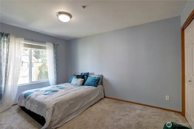 Generously sized bedroom includes a large closet with abundant shelves—perfect for maximizing storage space