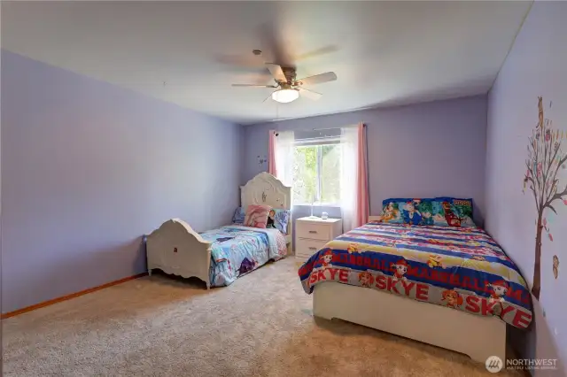 Bright and roomy bedroom easily fits two beds—perfect for sharing siblings or sleepovers.