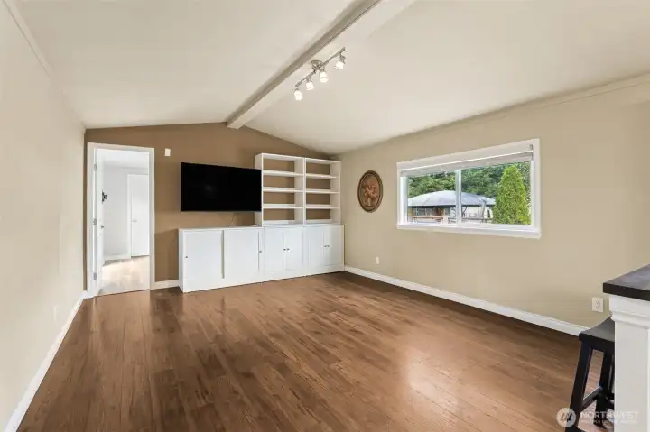 Living room with vaulted ceiling and custom cabinetry.
