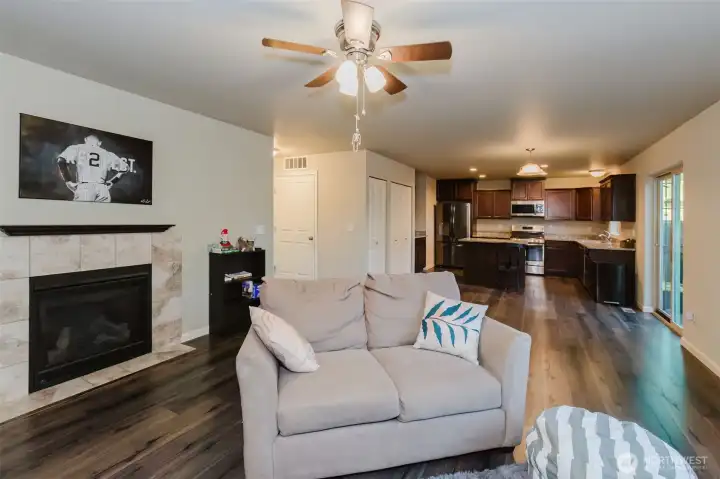 Cozy fireplace in living room with ceiling fan