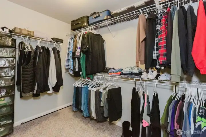 Walk in closet in primary bedroom