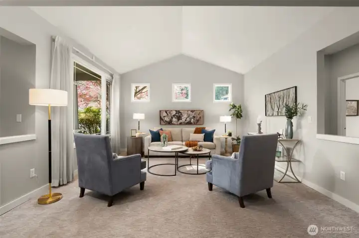Elegant millwork, vaulted ceiling over the formal living room with expansive windows allowing for an abundance of natural light to pour in.