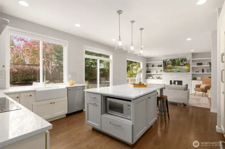 A center island providing an abundance of storage, mixer appliance lift, seating, and extended food preparation space.