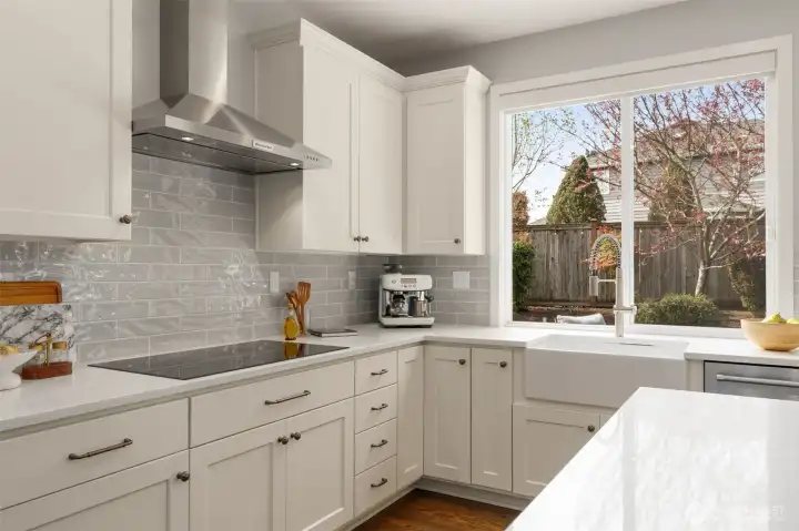 Convection cooktop with hood. Soft closing cabinetry. Back yard views.
