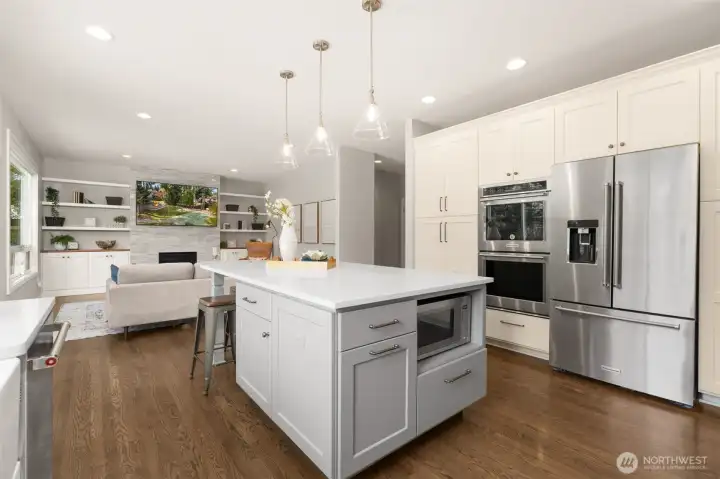 The kitchen flows seamlessly into formal and casual dining spaces.