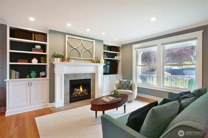 The living room had a glow up with a new direct vent fireplace, marble hearth, restored mantle, and custom built-in cabinetry with gracefully concealed media connections.