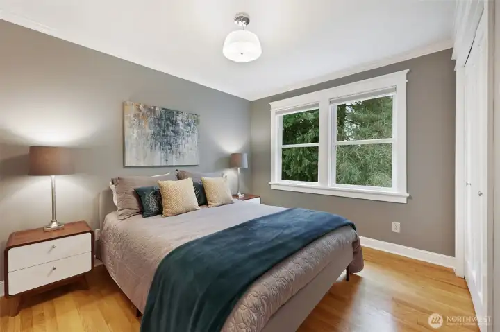 Third bedroom on the main level, overlooking the back yard for peaceful, treed views.