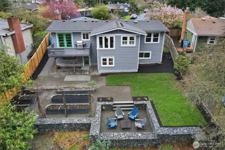 An aerial look at your backyard paradise. Pink and lavendar wisteria will soon be blooming on the arbor. (A fence could be added inside the gabion wall edge for young ones or pets).